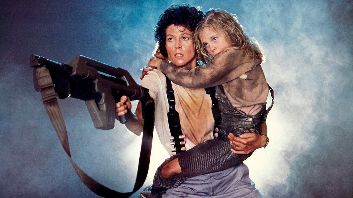 Sigourney Weaver as Ripley in Aliens, with Carrie Henn as Newt.