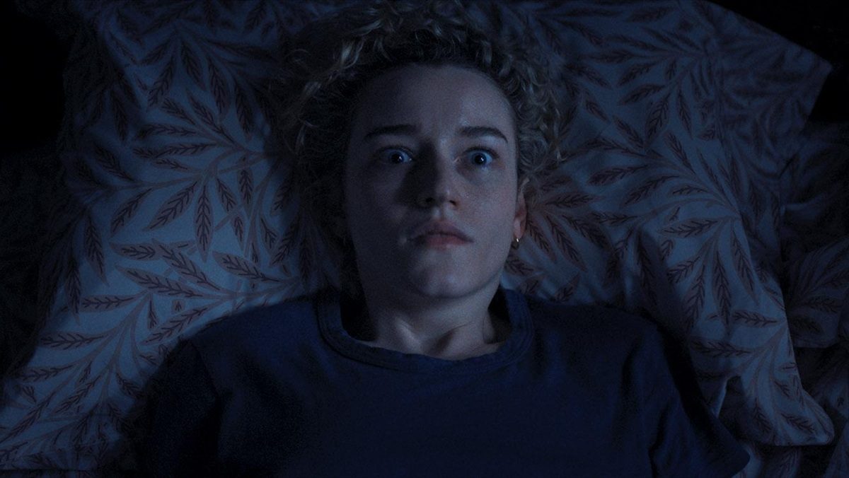 Julia Garner looks terrified in her bed in Weapons.