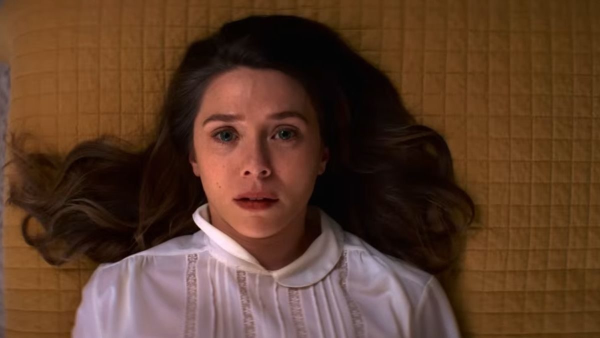 elizabeth olsen lies on a yellow blanket in eternity trailer