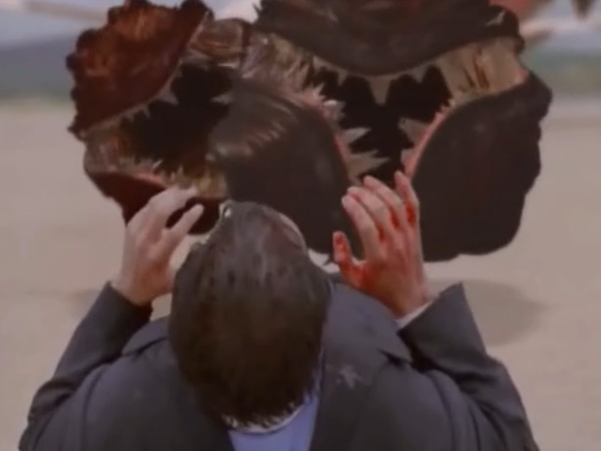 A man on the ground looks at two circle teeth monsters on The Langoliers