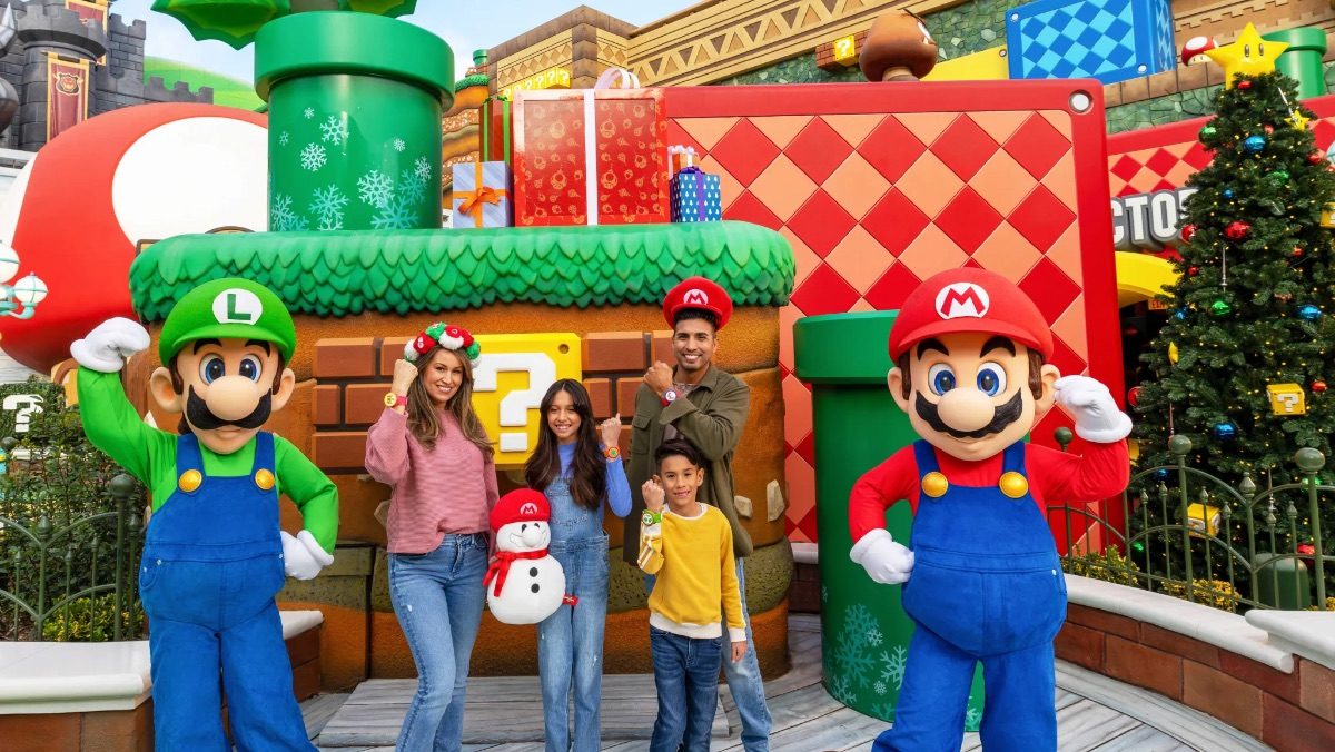 mario and luigi pose for picture at super nintendo world at universal studios during holiday season